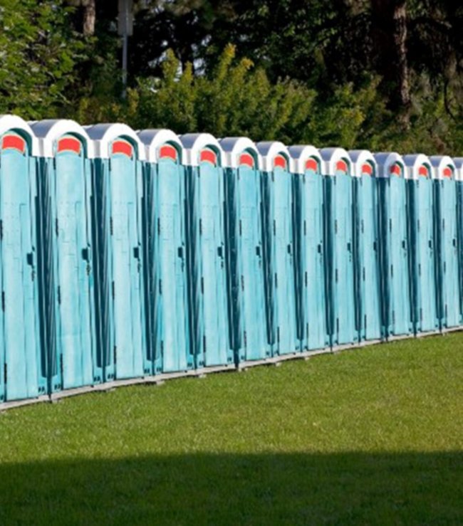 Multiple blue-colored portable toilets for rent for outdoor events  in New York & New Jersey